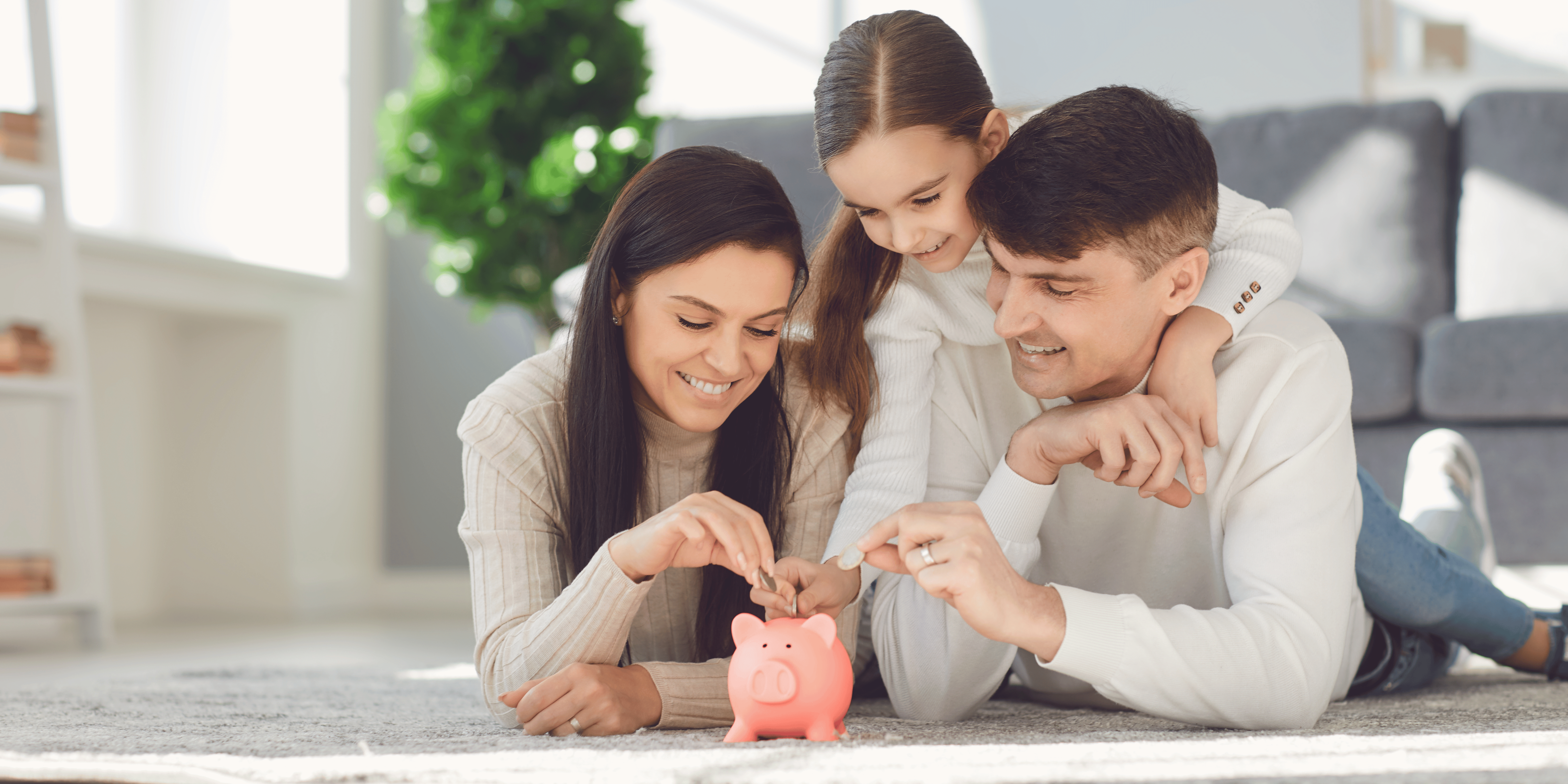 Family putting money in piggy bank