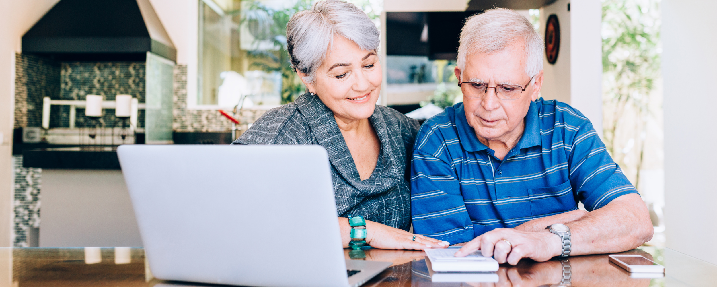 Elderly couple looking at common retirement planning mistakes on paper